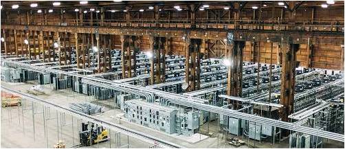 Aerial view of a mining farm powered by a large wind turbine array.