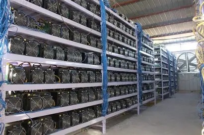 A large Bitcoin mining farm displaying multiple mining rigs in operation